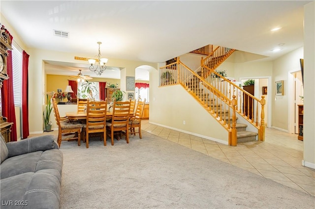 carpeted dining room with a notable chandelier