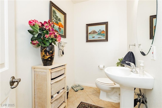 bathroom with toilet and tile patterned floors