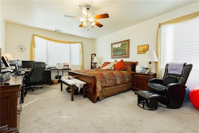 bedroom featuring ceiling fan and light carpet