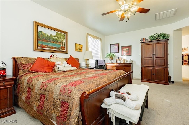 bedroom with ceiling fan and light carpet