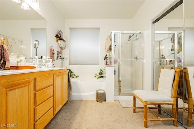 bathroom with vanity and independent shower and bath