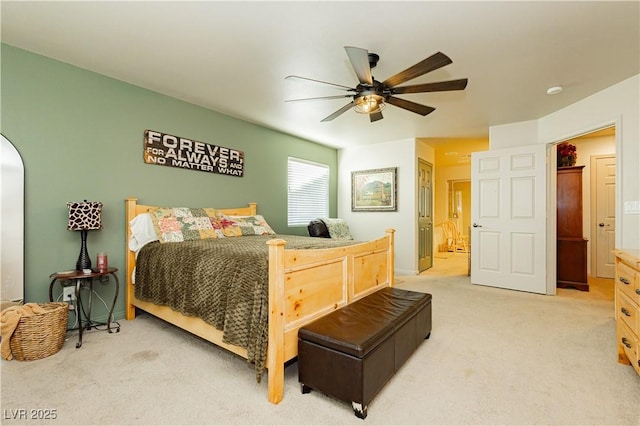 carpeted bedroom with connected bathroom and ceiling fan