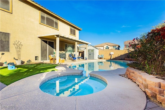 view of swimming pool featuring a yard, a patio, and a storage shed