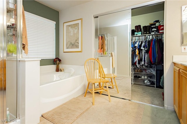 bathroom featuring a tub to relax in and vanity