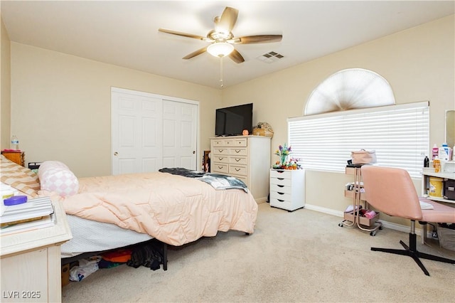 carpeted bedroom featuring a closet and ceiling fan