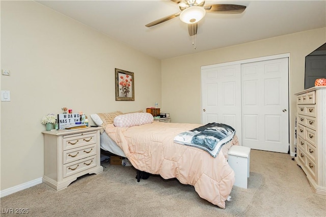 carpeted bedroom featuring ceiling fan and a closet