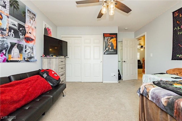 carpeted bedroom featuring a closet and ceiling fan