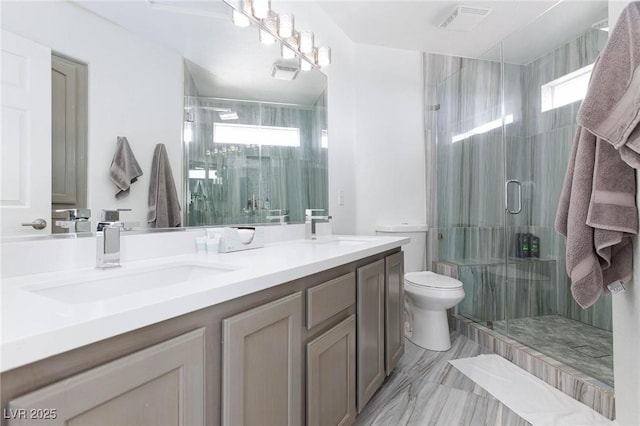 bathroom featuring vanity, toilet, and an enclosed shower