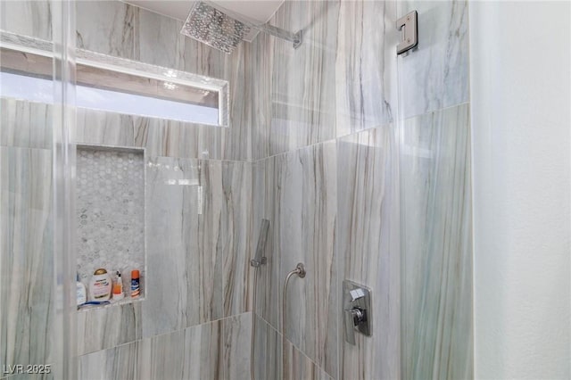 interior details with a tile shower