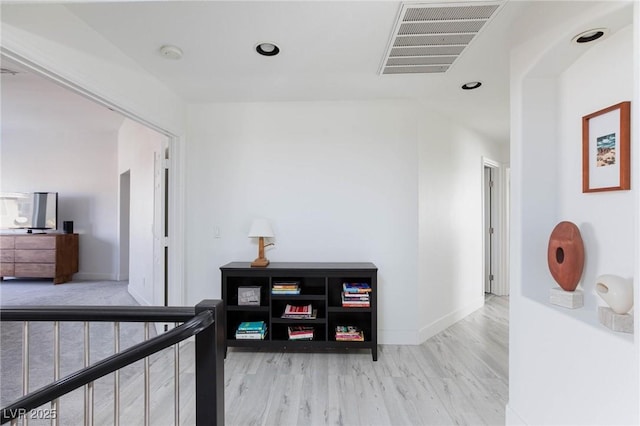 hallway with light hardwood / wood-style flooring