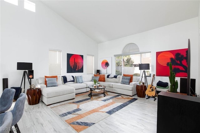 living room featuring light hardwood / wood-style floors and high vaulted ceiling