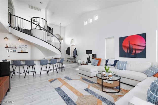 living room with bar and a towering ceiling