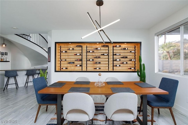 dining area featuring hardwood / wood-style floors and an inviting chandelier