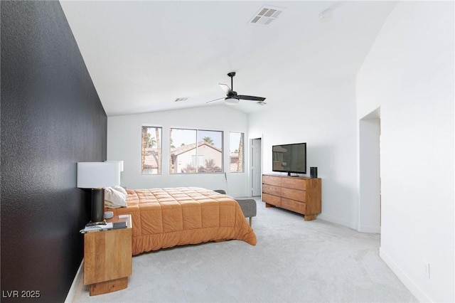 bedroom with ceiling fan, light colored carpet, and vaulted ceiling