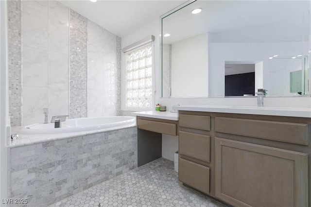 bathroom featuring tile patterned flooring, vanity, tile walls, and tiled tub