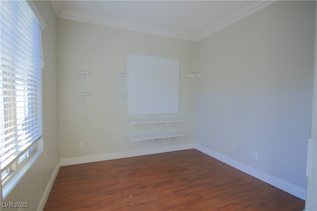 spare room with dark hardwood / wood-style flooring and ornamental molding