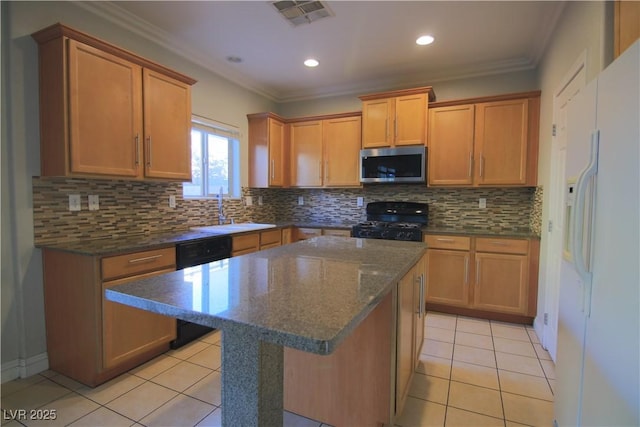 kitchen featuring decorative backsplash, a center island, light tile patterned flooring, and black appliances