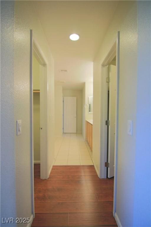 hallway with light hardwood / wood-style floors