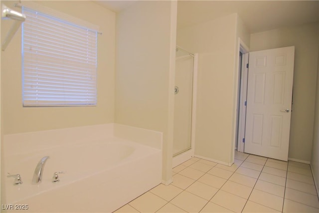 bathroom featuring tile patterned flooring and independent shower and bath