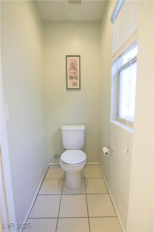 bathroom featuring tile patterned flooring and toilet