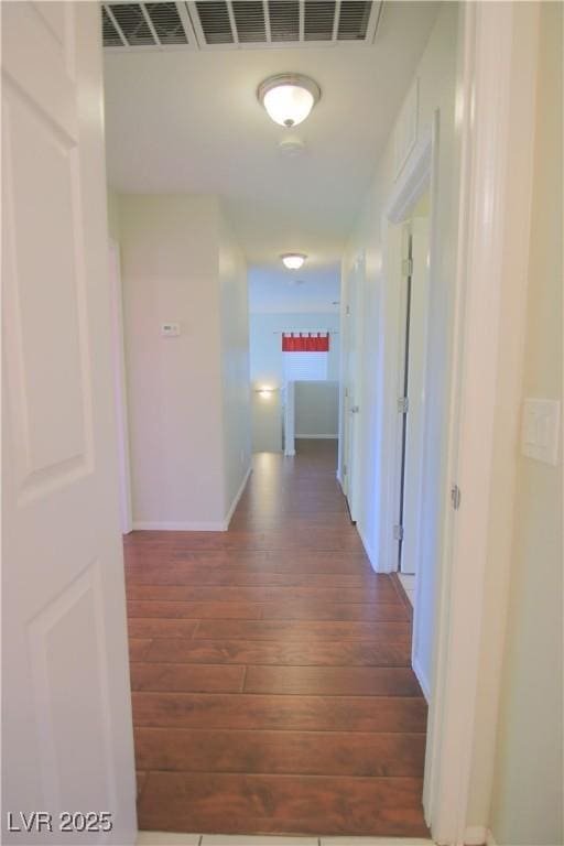 corridor with dark hardwood / wood-style flooring