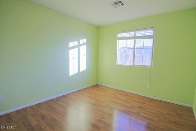 spare room featuring hardwood / wood-style flooring