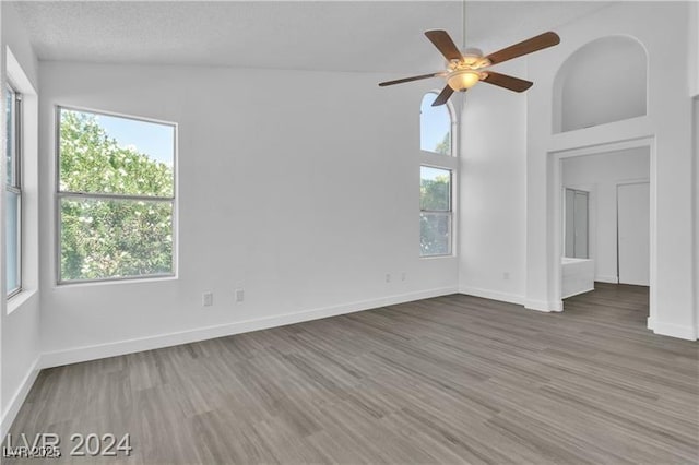 spare room with hardwood / wood-style flooring, ceiling fan, and vaulted ceiling