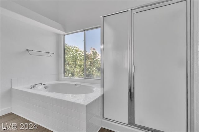 bathroom with plus walk in shower and wood-type flooring