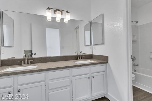 full bathroom with wood-type flooring, vanity, toilet, and shower / bathtub combination