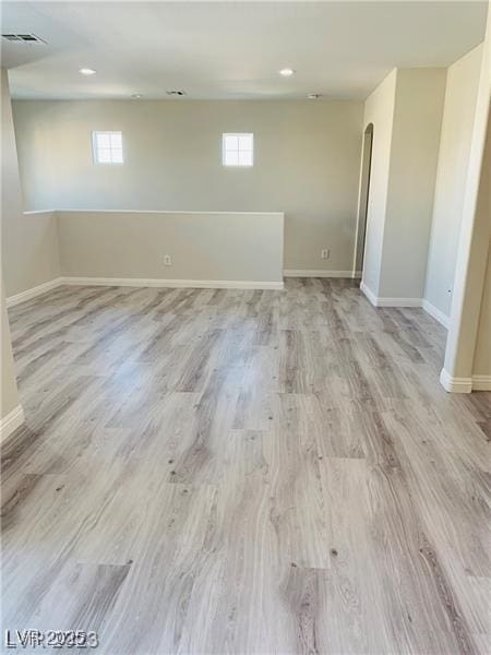 basement with light hardwood / wood-style flooring