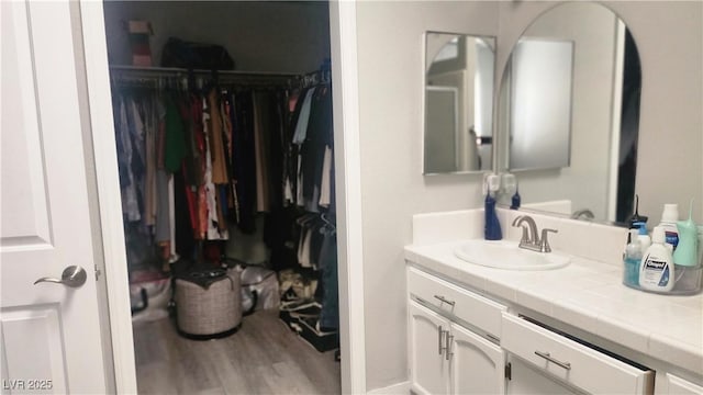 bathroom with vanity and hardwood / wood-style flooring