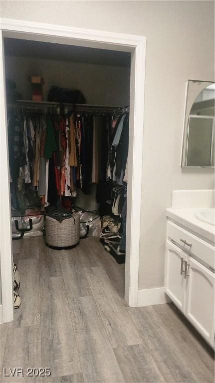 spacious closet with light hardwood / wood-style flooring