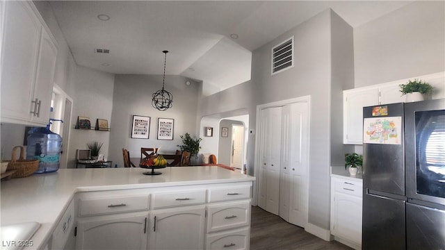 kitchen featuring white cabinetry, hanging light fixtures, fridge, and kitchen peninsula