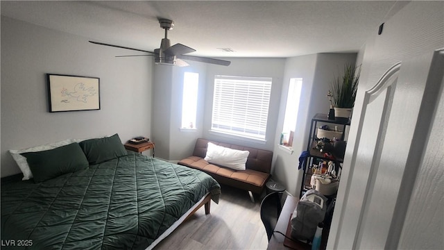 bedroom with hardwood / wood-style flooring and ceiling fan