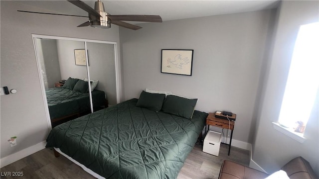 bedroom with hardwood / wood-style flooring, a closet, and ceiling fan