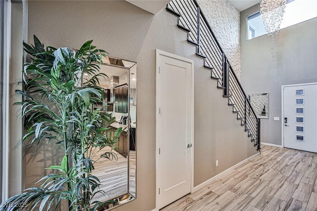 entrance foyer featuring a towering ceiling and a chandelier