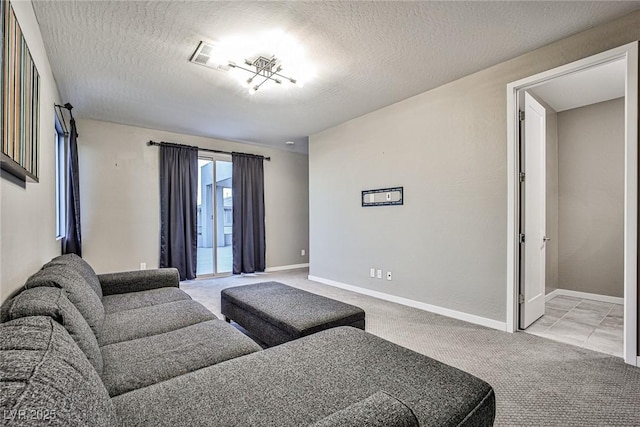 carpeted living room featuring a textured ceiling