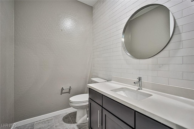 bathroom with tile patterned flooring, vanity, and toilet