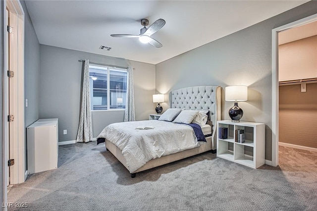 bedroom featuring carpet, a spacious closet, a closet, and ceiling fan