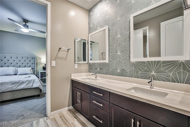 bathroom with hardwood / wood-style floors, vanity, and ceiling fan