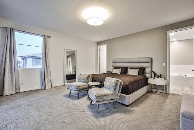 carpeted bedroom featuring ensuite bathroom