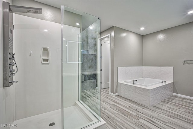 bathroom featuring hardwood / wood-style flooring and separate shower and tub