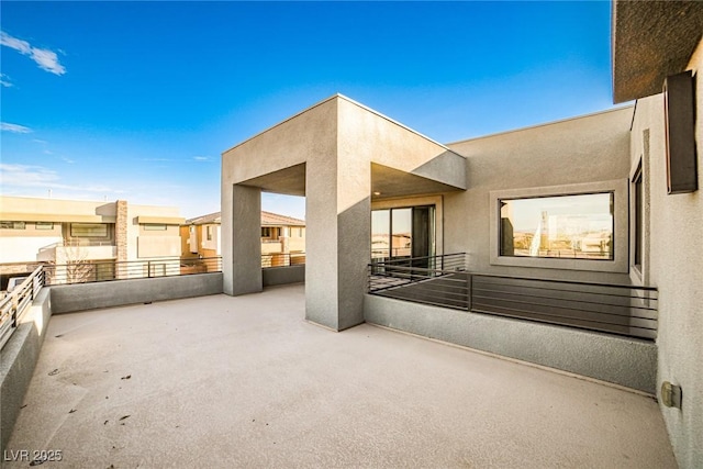 view of patio featuring a balcony