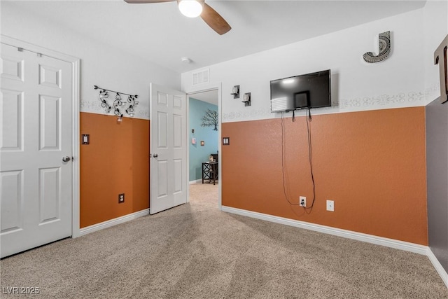 unfurnished bedroom with carpet flooring and ceiling fan