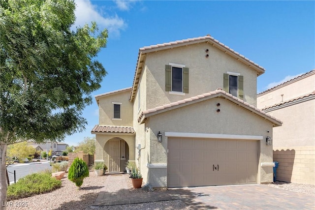 mediterranean / spanish-style house featuring a garage