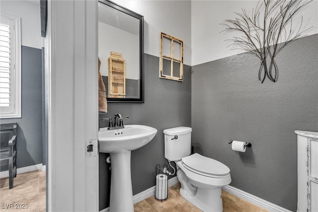 bathroom featuring tile patterned floors, toilet, and sink