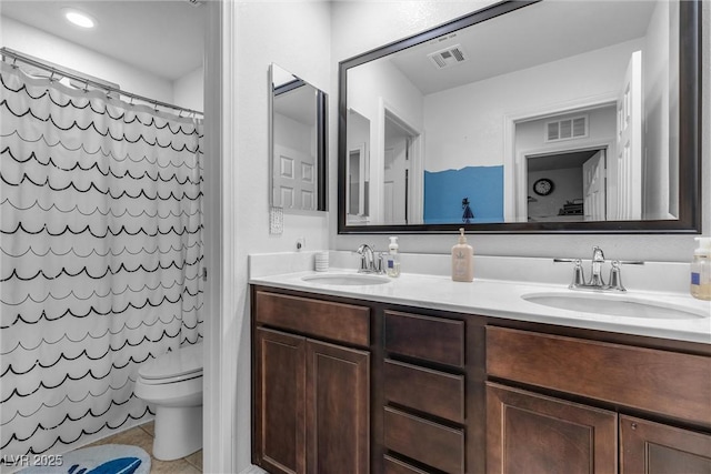 bathroom with tile patterned flooring, vanity, toilet, and walk in shower