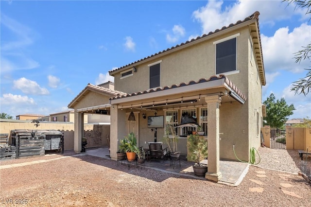 back of property with a patio