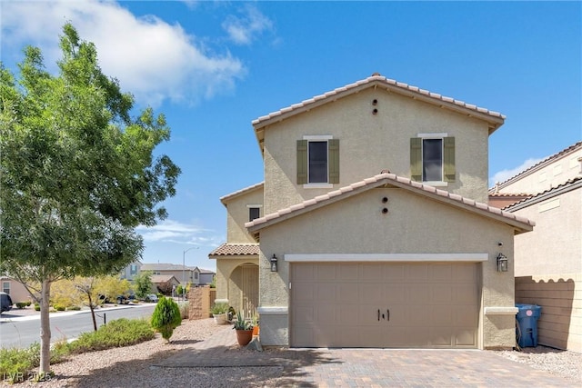 mediterranean / spanish house with a garage