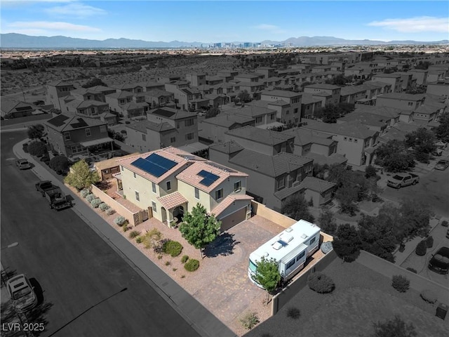 birds eye view of property with a mountain view